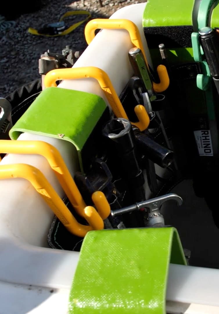 Yellow hooks on green-padded white tubing