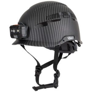 Carbon fiber helmet with mounted headlamp.