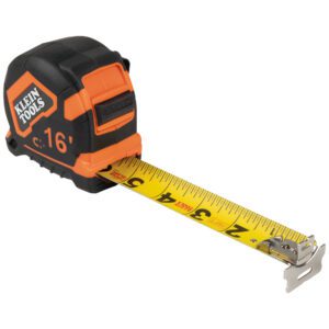 Black and orange tape measure, extended.